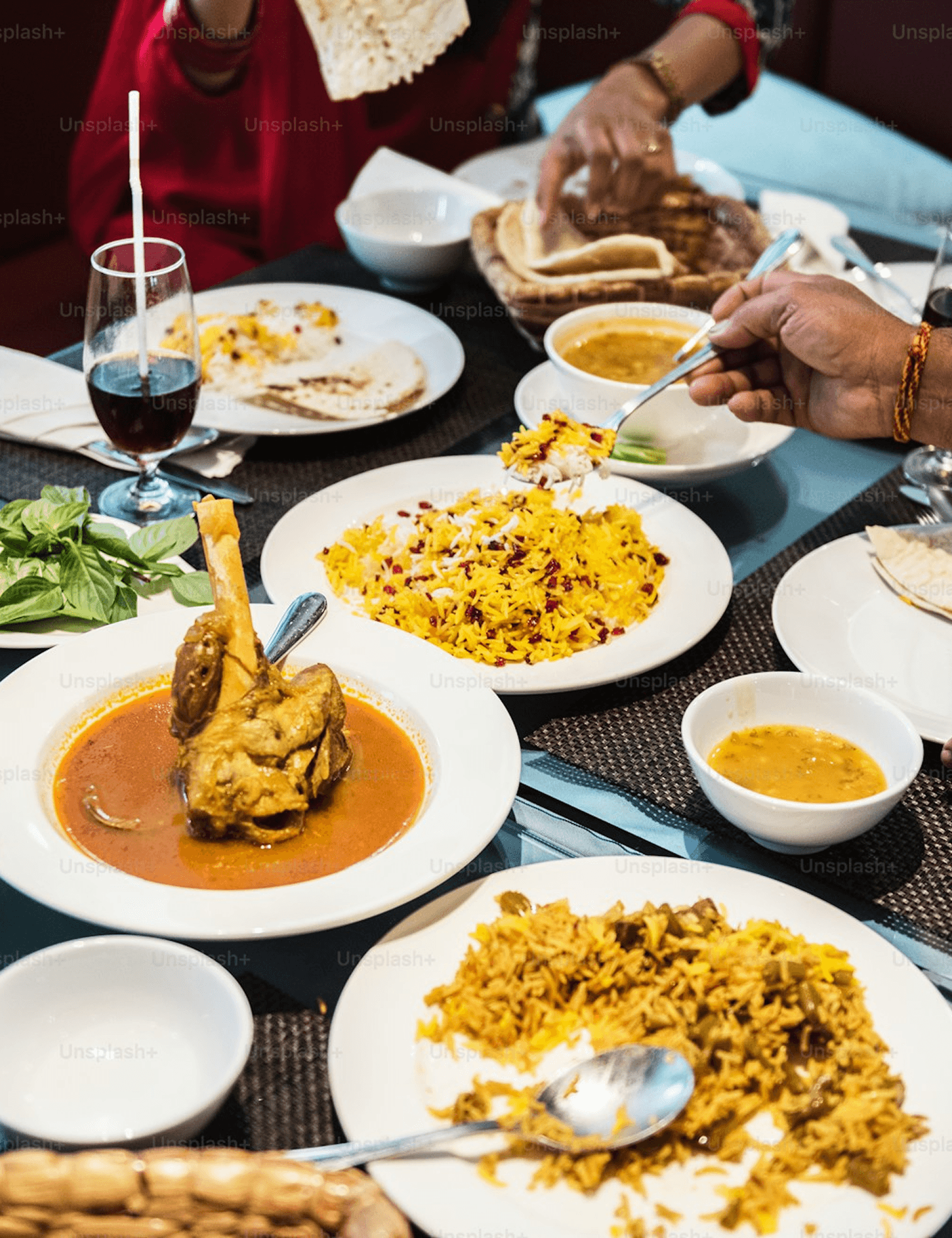Communal dining with biryani, curries and naan
